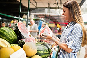 Picture of woman at marketplace buying fruits