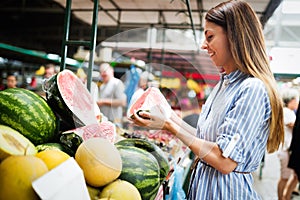 Picture of woman at marketplace buying fruits