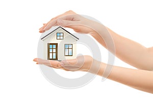 Picture of woman`s hands holding a house