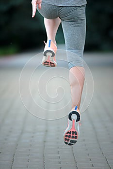 A picture of a woman`s legs running outdoors