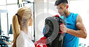 Picture of woman wearing boxing gloves in gym