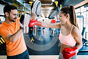 Picture of woman wearing boxing gloves in gym