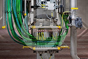 Picture of yellow colored electrical grounding cables and green signal cables in a industrial area