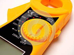 Picture of yellow digital clamp meter that using for measuring electrical current, voltage and resistance