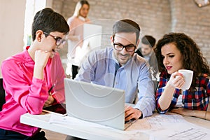 Picture of young architects discussing in office