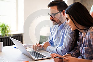 Picture of young architects discussing in office