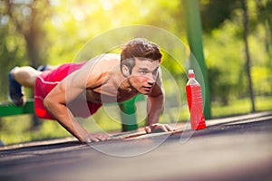 Picture of a young athletic man doing push ups