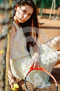 Picture of young beautiful brunette woman playing tennis on cour