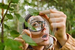 Picture of young botanist with magnifying glass
