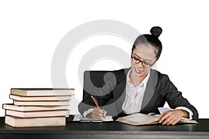 Young business woman writing on the clipboard