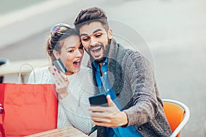 Picture of young couple with shopping bags and credit card