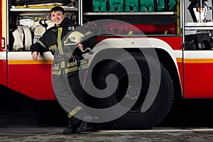 Picture of young fireman man near fire truck