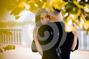 Picture of young romantic couple hugging in the park