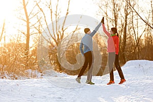 Picture of young sportsmen doing handshake in winter park at afternoon