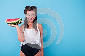 Picture of young woman holding a big slice watermelon