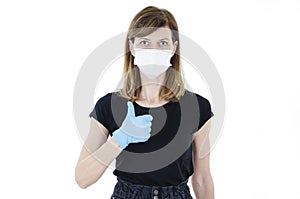 Picture of young woman showing sign OK, invoking to not panic, lady wearing protective face mask and disposable medical gloves
