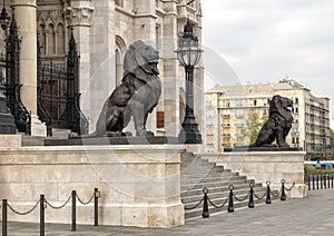 Bronze lion statues flanking the East entrance of the Hungarian Parliament Building, Budapest photo