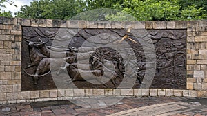 The Shawnee Trail, a bronze relief mural by Anita Pauwels, part of a public art installation titled `Cattle Drive` in Central Park