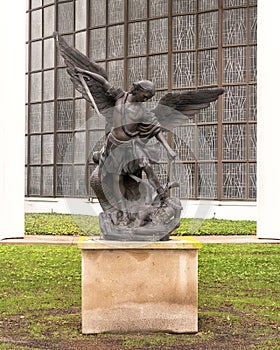 Bronze statue depicting Saint Michael the Archangel vanquishing Satan on display on the grounds of Saint Monica Parish in Dallas photo