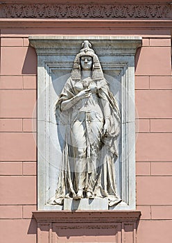 Ancient Egyptian statue of a woman on the front of the Museum of Egyptian Antiquities in Cairo, Egypt.