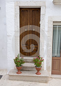 Closeup view of steps and front door of a home in Locorotondo, southern Italy