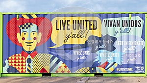 Cowboy and `Live United` messages in multiple languagespainted on a large trash bin at the State Fair of Texas in 2020.