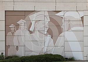 Distinctive wall mural featuring a student graduating along Interstate 30 in Arlington, Texas.