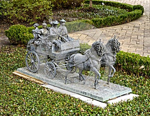 Detailed bronze sculpture of a horse drawn carriagne in the front of a mansion in Highland Park, Dallas, Texas. photo