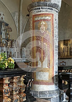 Fresco depicting Queen Theodelinda on a column close to the altar in the Church of Saint George in Varenna.