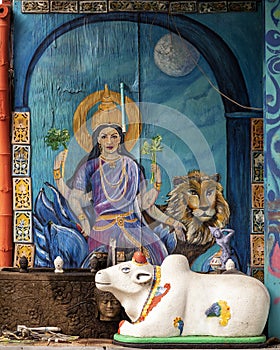 Hindu goddess, lion and Indian Brahman outside the Cosmic Cafe on Oak Lawn in Dallas, Texas.