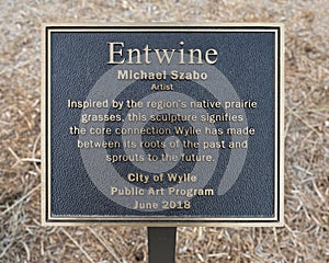 Information plaque for `Entwine` by Michael Szabo in the City of Wylie, Texas.