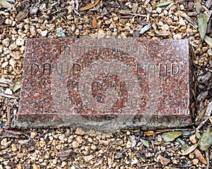 Memorial stone for `Teacher With Heart`, a metal sculpture by John Dennard located at Dowell Middle School in McKinney, Texas.