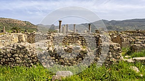 Peristyle house ruins along the Decumanus Maximus at the Archaeological Site of Volubilis in Morocco. photo