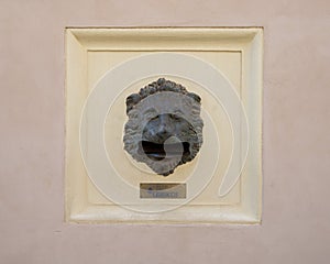 Post box created by bronze lion`s head whose mouth is a letter slot on Calle Seal in the Alhambra, Granada photo