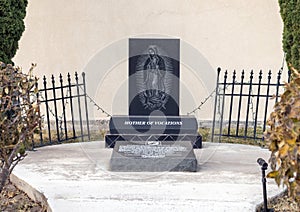 Small POW-MIA memorial with engraved stone featuring Mary, Mother of Vocations, outside Saint Mary Catholic Church in Marfa