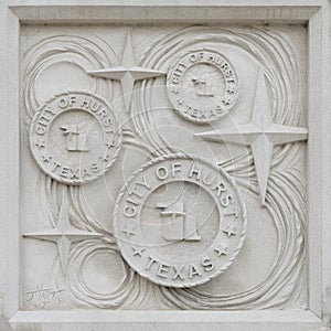 Relief on one of the three monolithic columns that comprise `Remembrances of My Home Town` by Janice Hart Melito in Hurst, Texas.