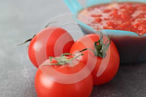 Transfered platchooped tomates from the canning to blue bowl photo