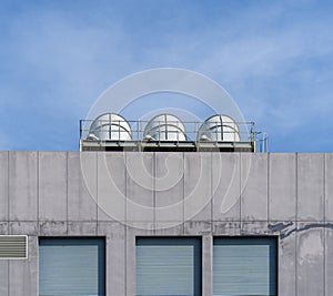 Pictures buildings` minimal style consists of concrete wall windows and ventilation pipes with a blue sky background