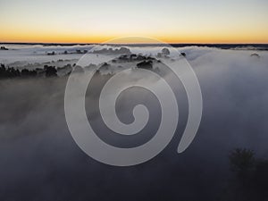 Pictures of the drone flight over the fog. River, forest, fields and meadows on a misty summer dawn. Summer