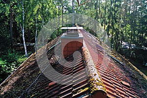 Pictures of the inspection and control of the chimney and the roof of a single family house with a drone, aerial photograph