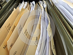 A pictures of many office files in a file cabinet