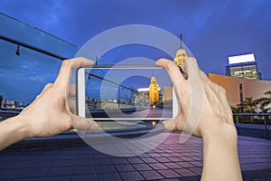 Pictures on mobile smart phone in Night view Old Clock Tower in Hong Kong