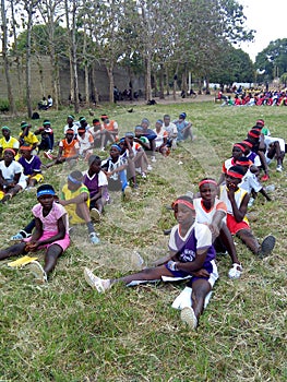 Sport Students sitting on the grass for sport class