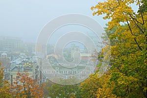 Picturesque aerial landscape view of ancient Podil neighborhood during fog. Mysterious cityscape