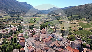 Picturesque aerial view of Cucugnan commune with main landmark 17th-century windmill, Aude department, southern France