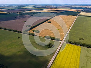 Picturesque aerial view of farmland on multicolored fields with crops sown and grown agriculture ripe for harvest wheat rye and