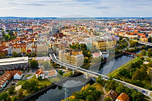 Picturesque aerial view of old buildings of Pilsen cityscape with river and ponds