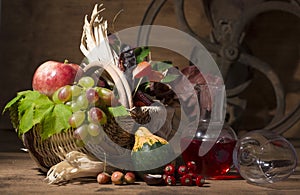 Picturesque autumn composition with basket, fruits, pumpkin, mug