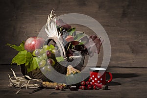 Picturesque autumn composition with basket, fruits, pumpkin, mug