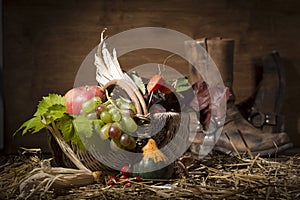 Picturesque autumn composition with basket, fruits, pumpkin, win